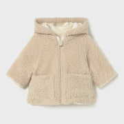 Closer look at the Mayoral reversible coat showing detail of the beige shearling side