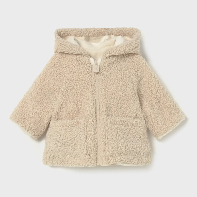 Closer look at the Mayoral reversible coat showing detail of the beige shearling side