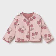 Cherry print side of the baby girl's reversible jacket.