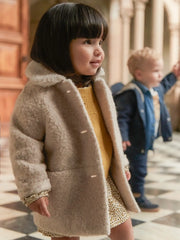 Baby girl wearing the Mayoral shearling coat.