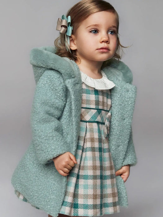 Baby girl modelling the Mayoral shearling coat.