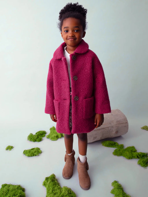 Girl modelling the Mayoral shearling coat.