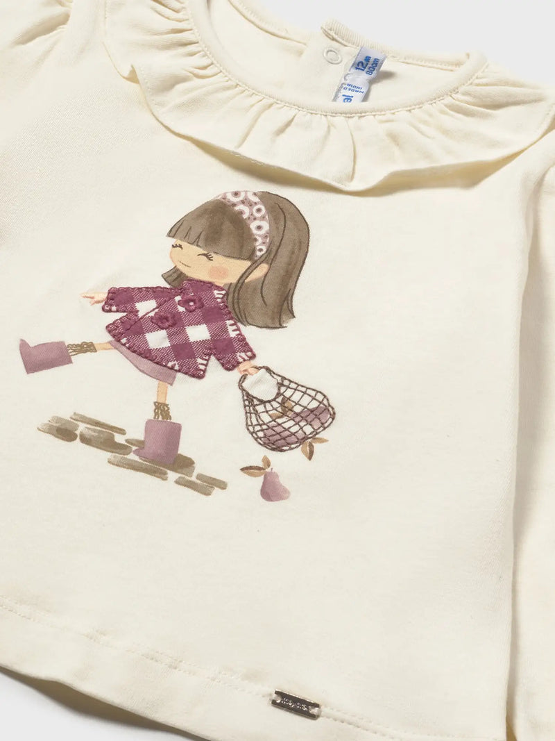 Cream top with shopping girl print on the front.