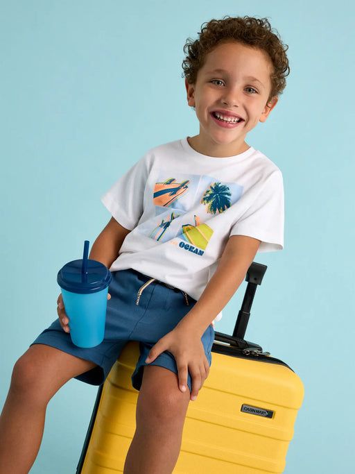 Smiling boy modelling the Mayoral surfer shorts set.