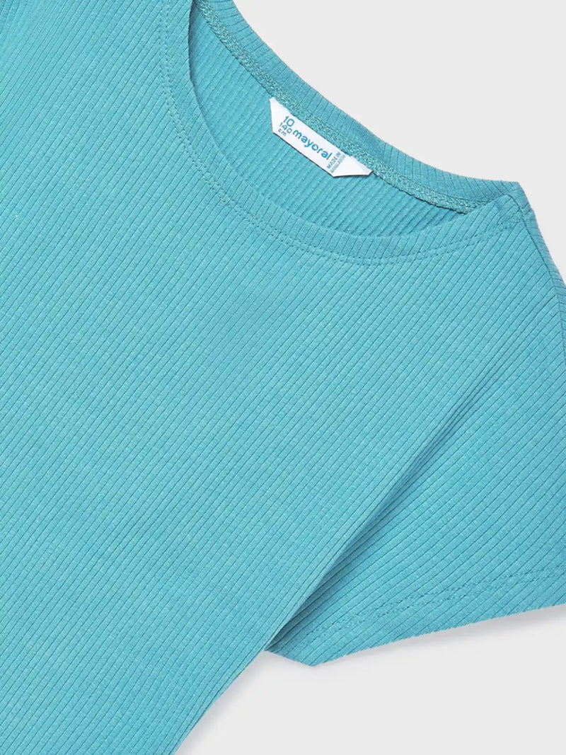 Closer view of the green t-shirt.