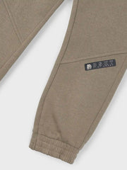 Mayoral brown track bottoms with logo patch at the knee.