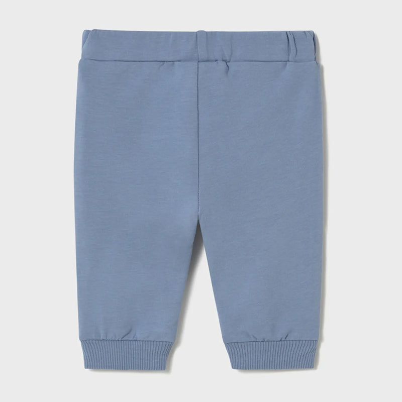 Baby boy's blue track bottoms.