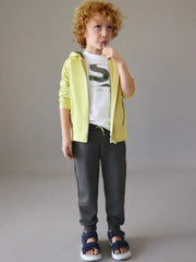 Boy modelling the Mayoral tracksuit.