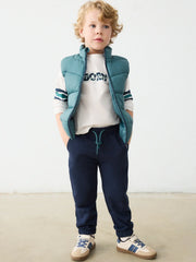 Boy modelling the Mayoral tracksuit.