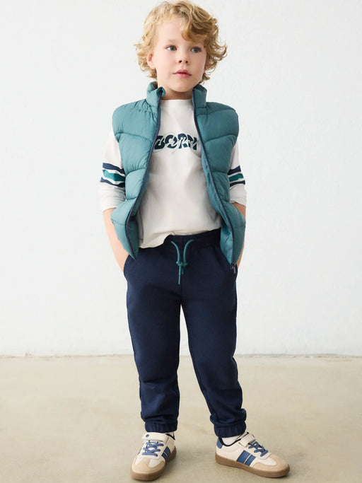 Boy modelling the Mayoral tracksuit.