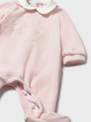 Mayoral velour babygrow with embroidered flowers on the chest.