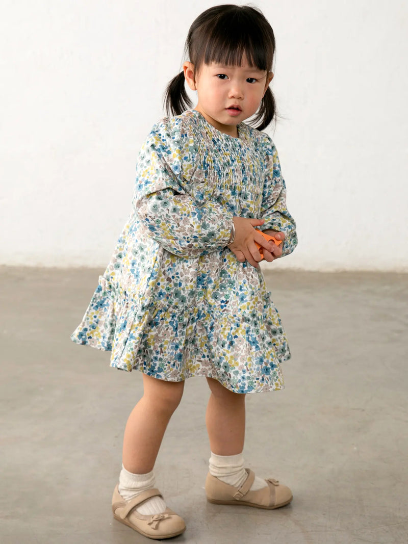 Baby girl wearing the Mayoral velvet dress.