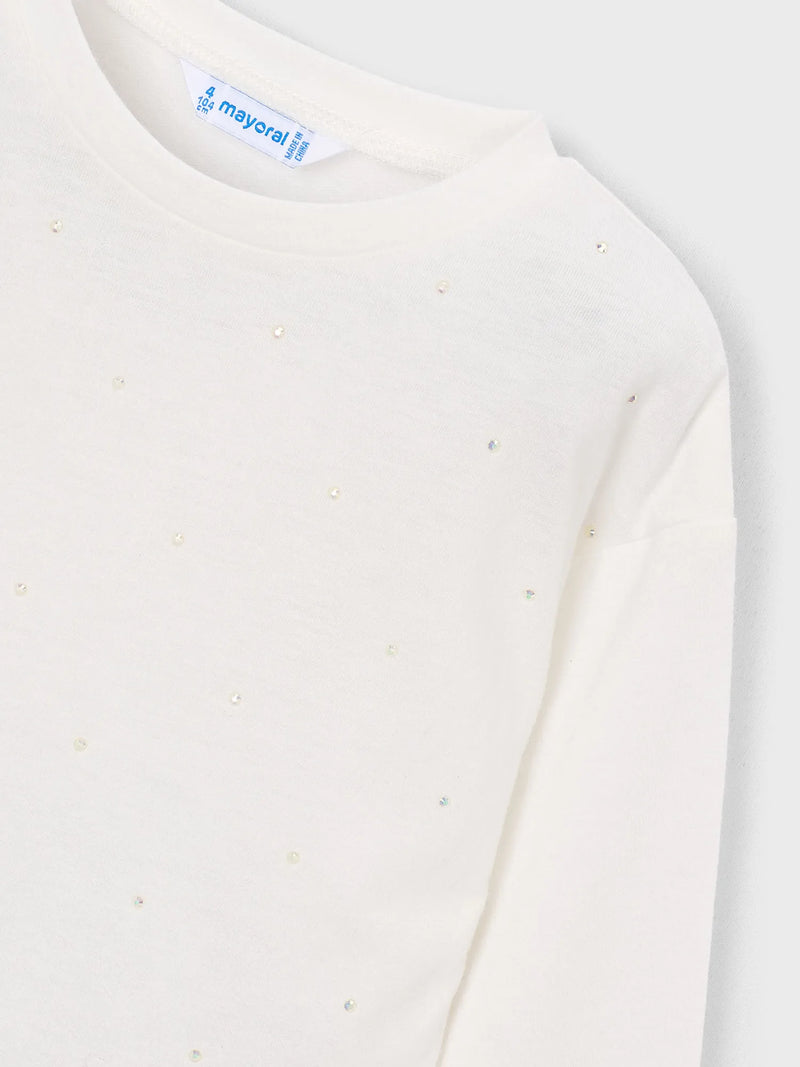 Long sleeve t-shirt dotted with sparkling rhinestones.