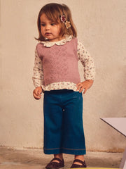 Baby girl modelling the Mayoral vest & jeans set.