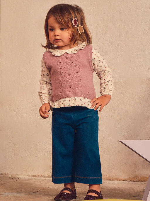 Baby girl modelling the Mayoral vest & jeans set.