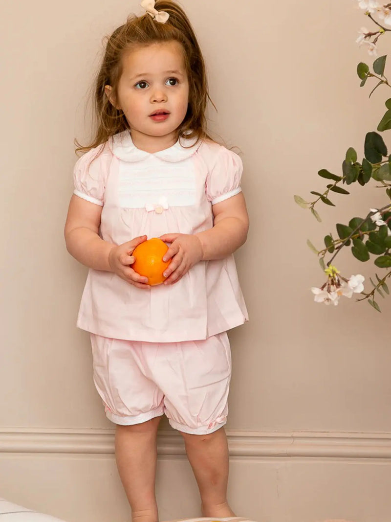 Girl wearing the Mintini Baby smocked bloomers set.