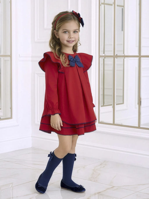 Smiling Girl modelling the Miranda bow dress.