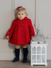 Baby girl modelling the Miranda button coat.