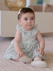 Baby girl wearing the Miranda floral print dress.
