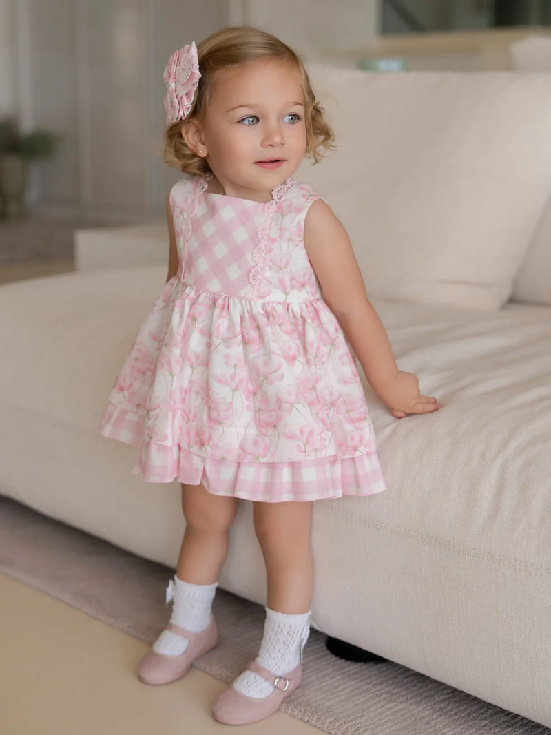 Baby girl modelling the Miranda floral print dress.