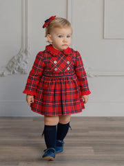 Baby girl wearing the Miranda tartan dress.