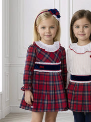 Girl in red tartan dress by Miranda.