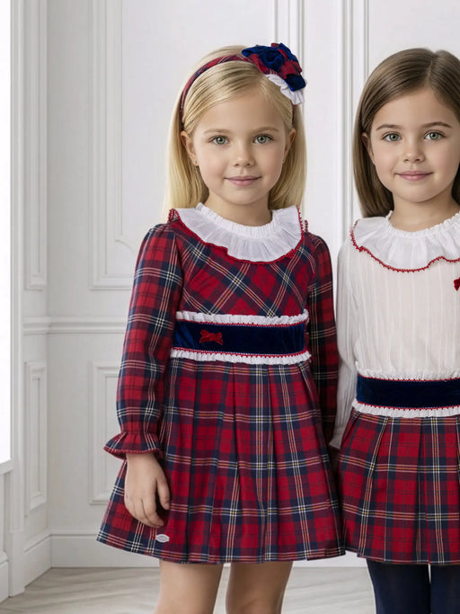 Girl in red tartan dress by Miranda.