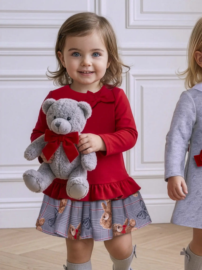 Girl wearing the Miranda teddy bear dress.