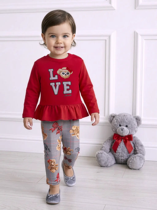 Smiling baby girl modelling the Miranda teddy bear leggings set.