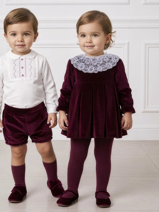 Baby girl wearing the Miranda velvet dress.
