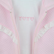 Closer view at the Pex bianca t-shirt with pink embroidered hearts and bows.