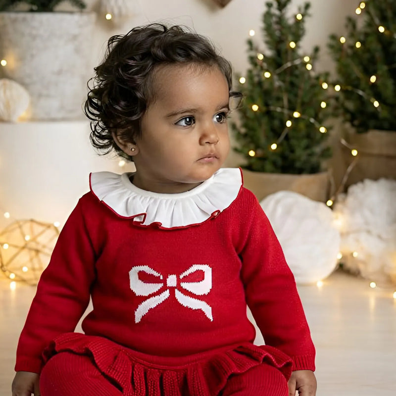 Baby girl modelling the Pex bow knitted set.