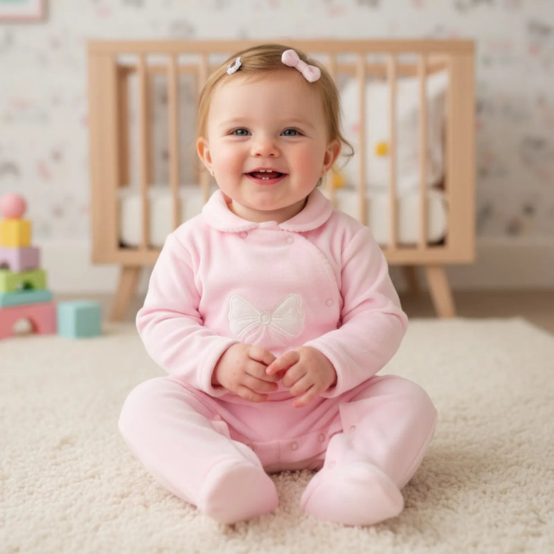 Smiling baby girl modelling the Pex hallie babygrow.