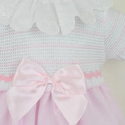 Closer look at the Pex tabitha dress showing detail of the pink ribbon bow on the front.