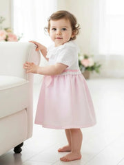 Baby girl wearing the Pex tabitha dress.