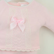 Closer look at the Pex tilda leg warmer set showing detail of the satin bow on the chest.