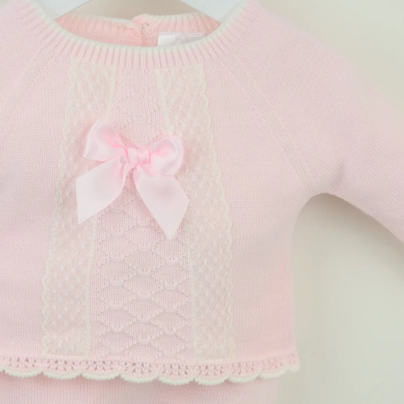 Closer look at the Pex tilda leg warmer set showing detail of the satin bow on the chest.