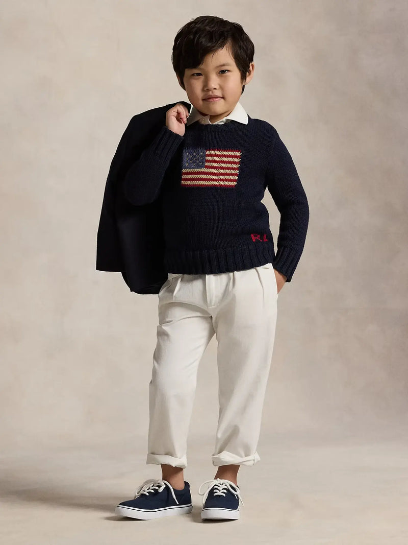 Boy modelling the Ralph Lauren flag sweater.