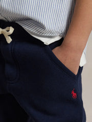 Smiling Boy modelling the Ralph Lauren fleece joggers.