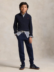Boy modelling the Ralph Lauren half zip cable knit sweater.