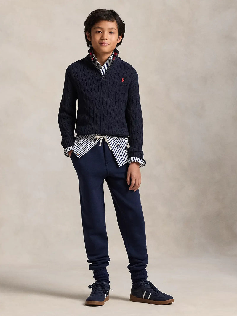 Boy modelling the Ralph Lauren half zip cable knit sweater.
