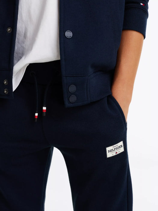 Navy Tommy Hilfiger track bottoms with white logo patch.