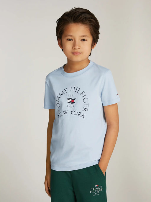 Boy wearing the Tommy Hilfiger arch logo t-shirt.