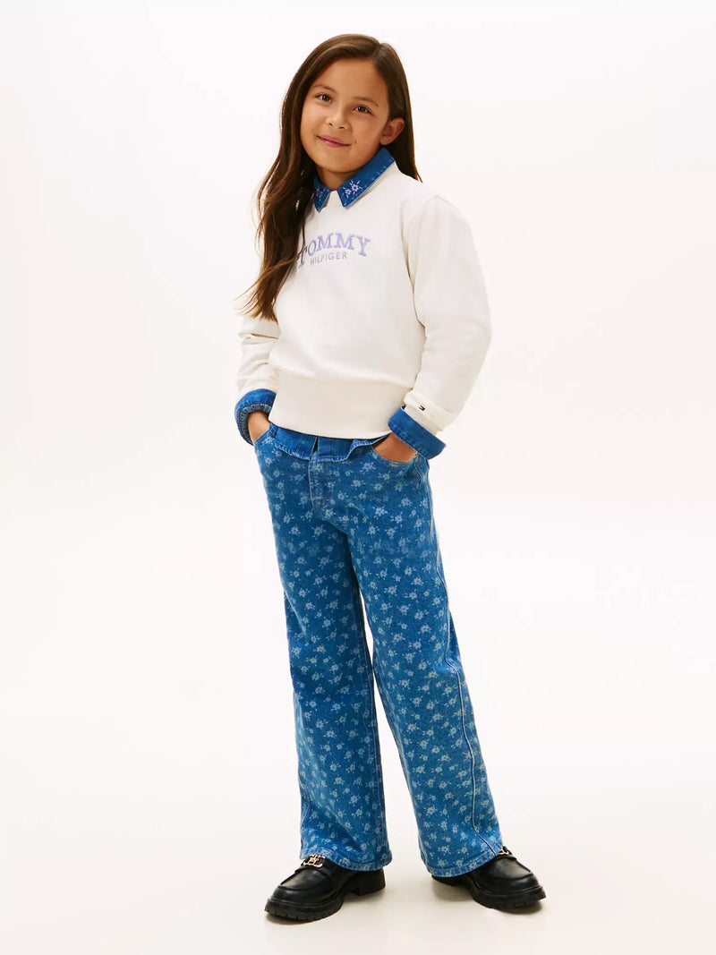 Girl wearing the Tommy Hilfiger arched logo sweatshirt.