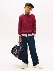Boy wearing the Tommy Hilfiger cable knit sweater.
