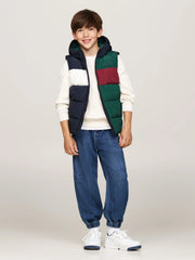 Boy modelling the Tommy Hilfiger colourblock gilet.