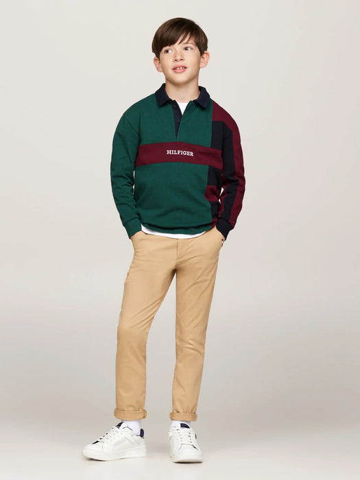 Boy modelling the Tommy Hilfiger colourblock polo shirt.