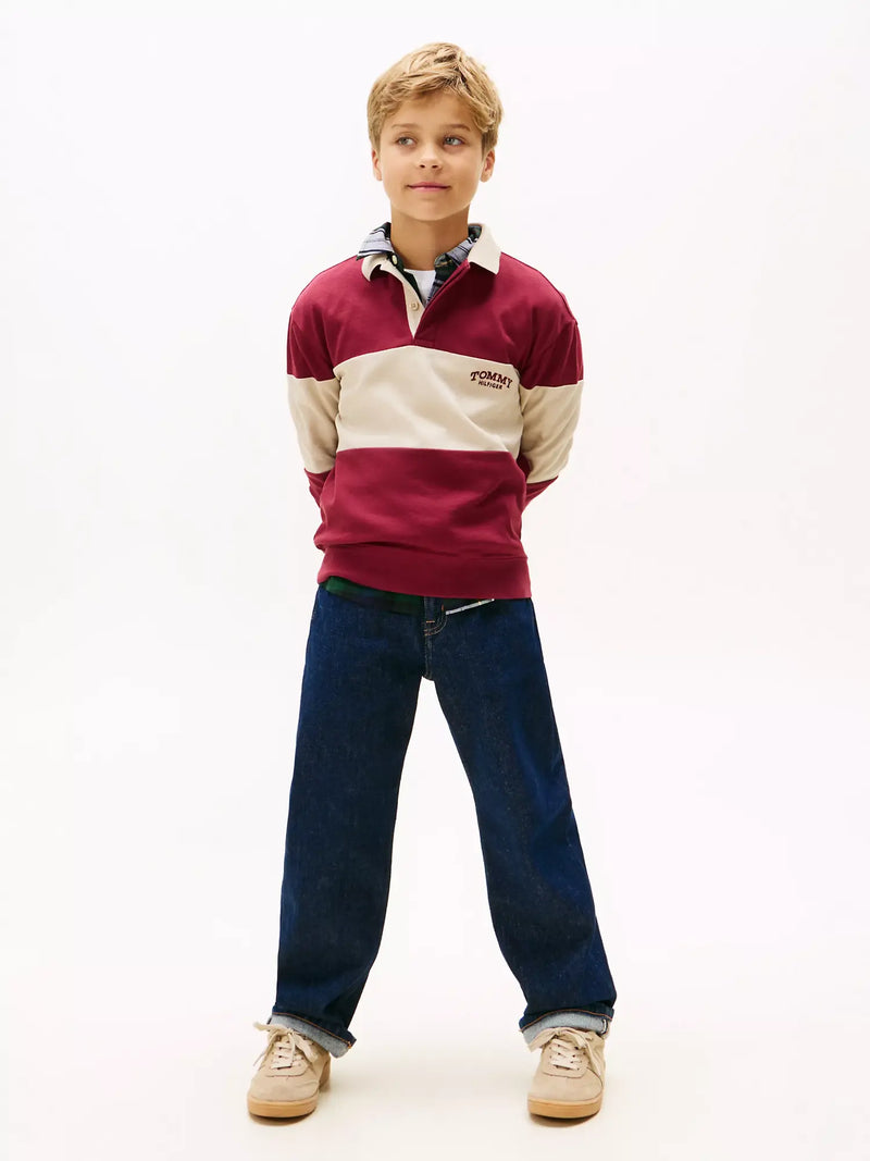 Boy modelling the Tommy Hilfiger colourblock polo shirt.
