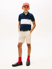 Boy modelling the Tommy Hilfiger colourblock polo shirt.