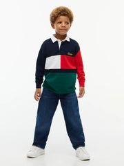 Boy modelling the Tommy Hilfiger colourblock rugby shirt.